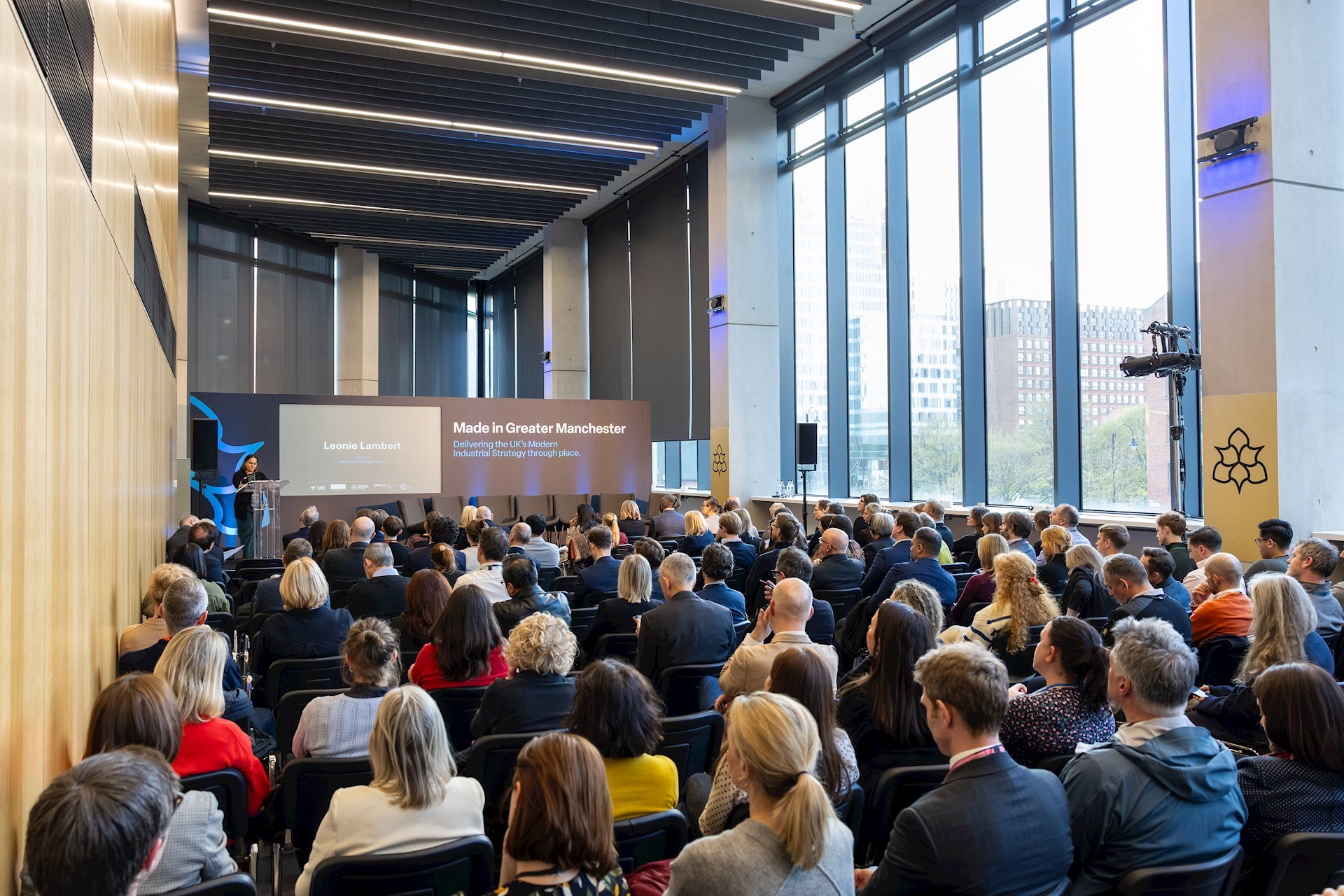 Large audience at the event looking towards the front of the room