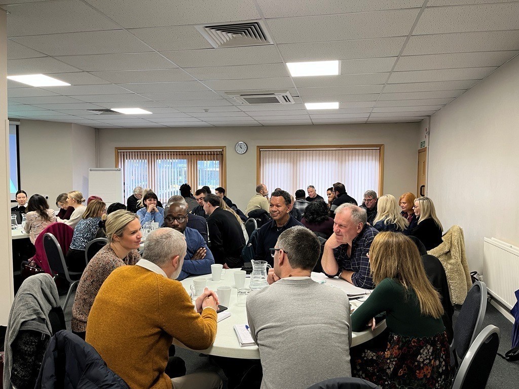 Colleagues around tables at the Carbon Literacy Action Day training session