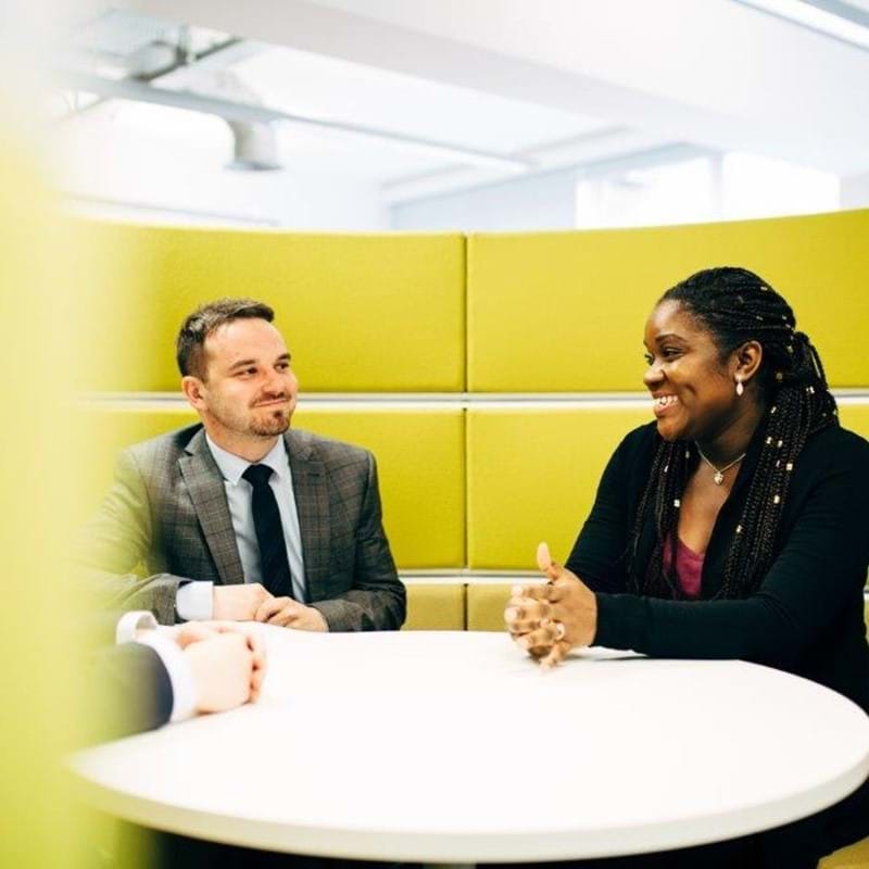 Image to two people in a meeting booth