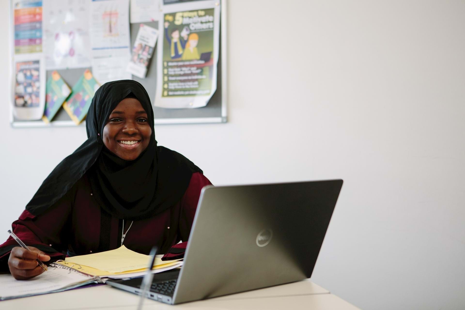 Image from an interview - with notes and a laptop on a desk