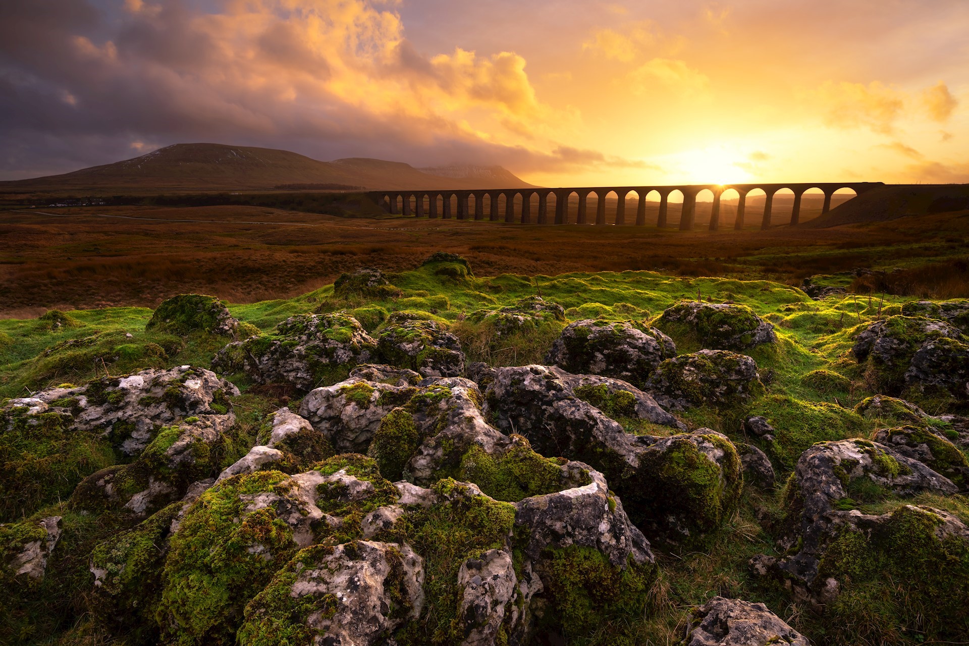 Dramatic Ribblehead Viaduct Sunset with Limestone Pavement, Yorkshire Dales, UK. credit: Daniel_Kay via Getty Images