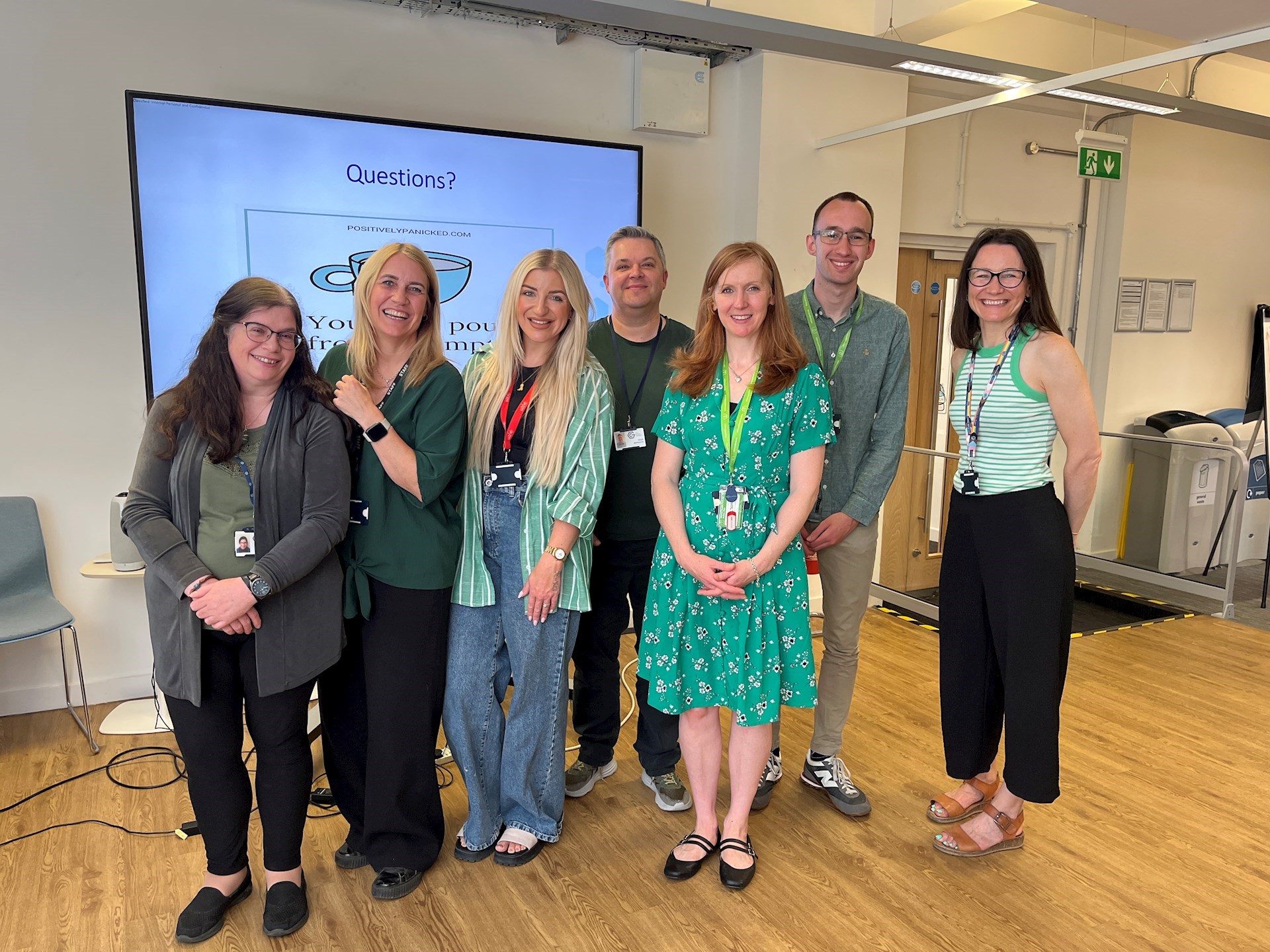 Group of colleagues wearing green for Mental Health Awareness Week
