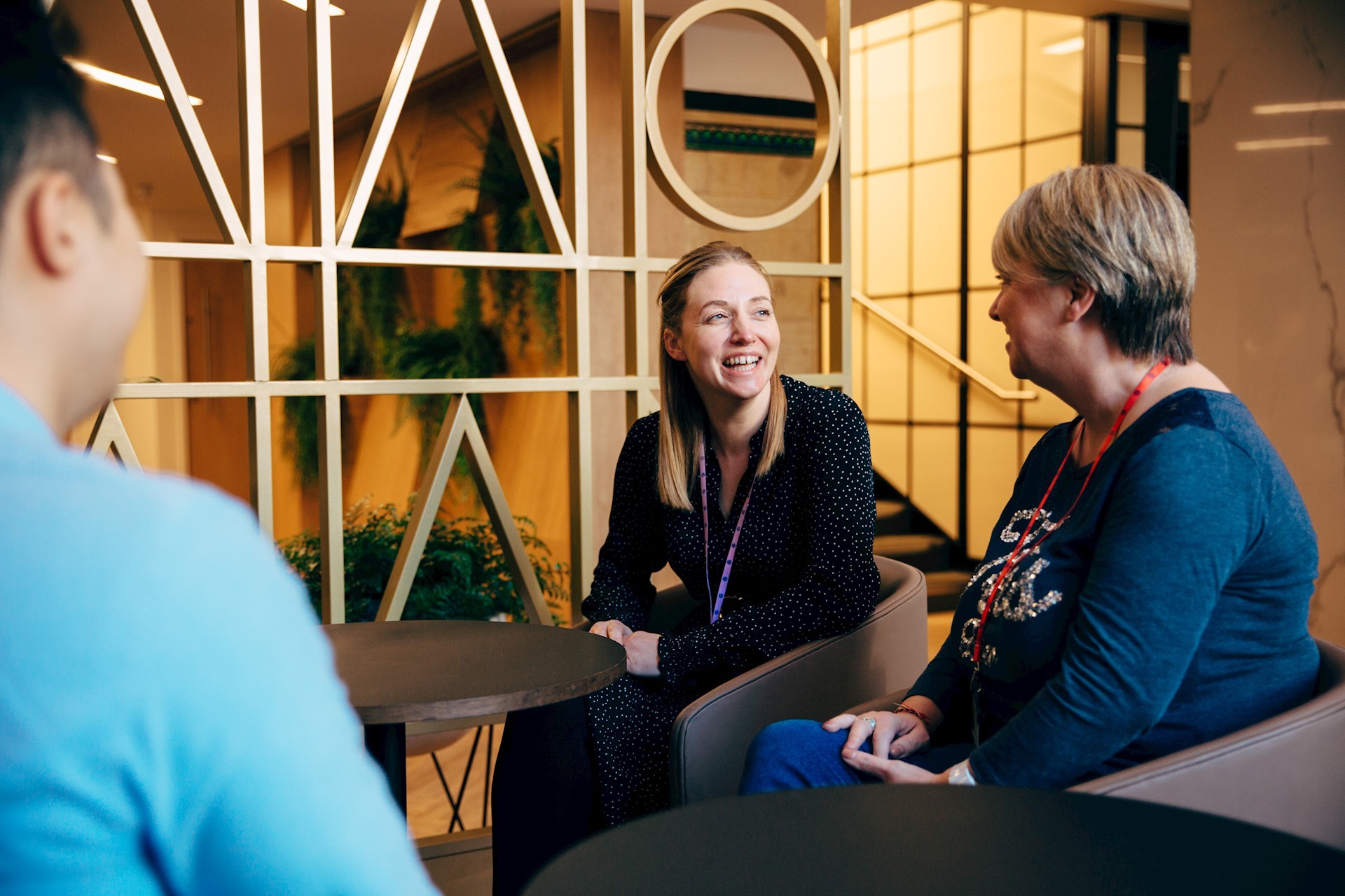 Image of colleagues smiling in a relaxed meeting setting