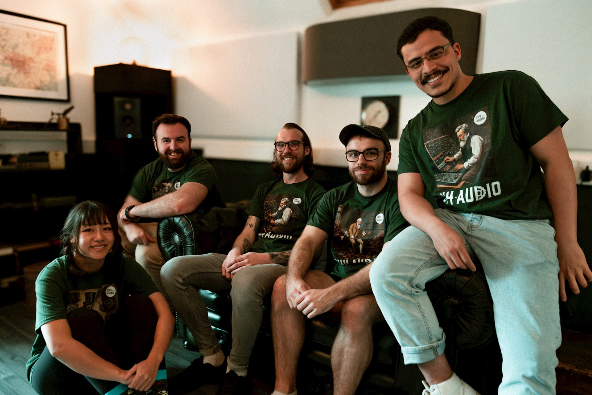 Five business owners smiling sitting on a sofa