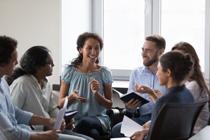 Stock image of a group of six people having a conversation 